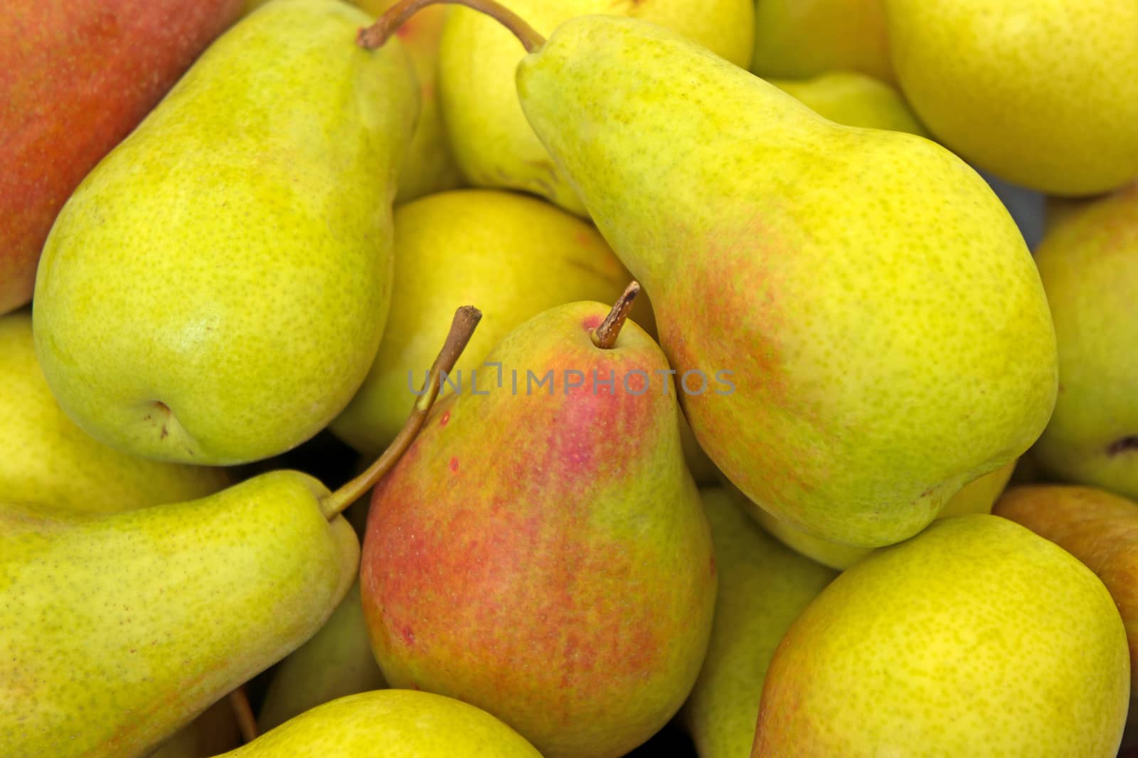 Heap of ripe sweet pears in the market
