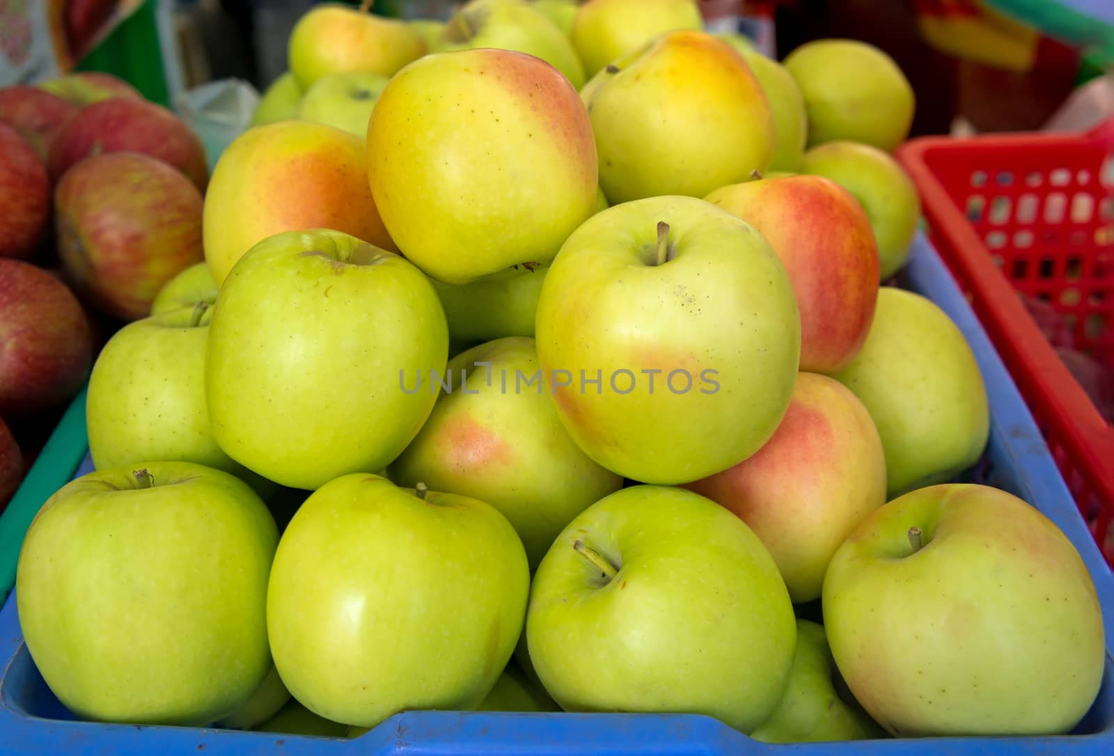 Lots of green ripe apples on the street market