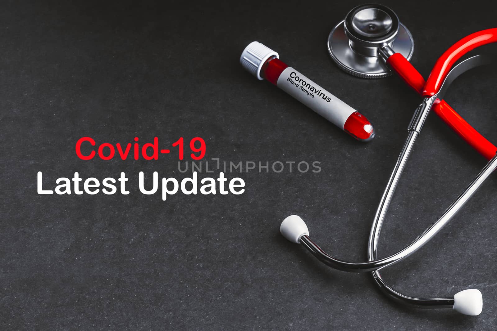 COVID-19 LATEST UPDATE text with stethoscope and blood sample vacuum tube on black background by silverwings