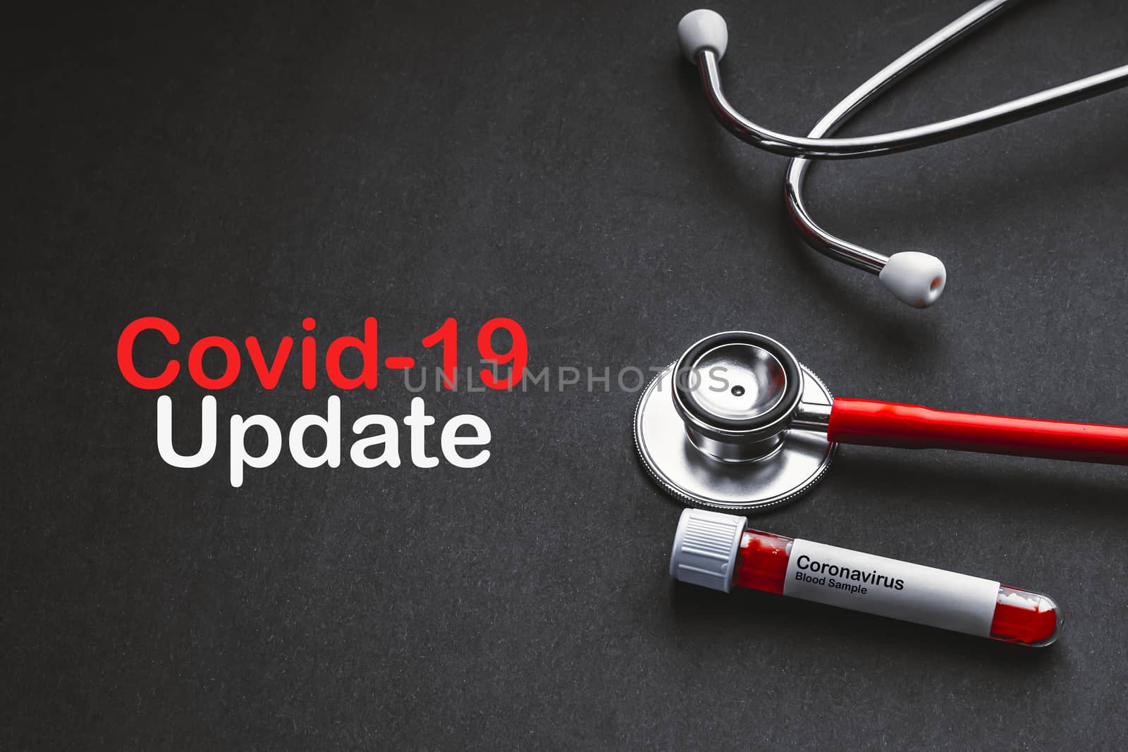 COVID-19 UPDATE text with stethoscope and blood sample vacuum tube on black background by silverwings