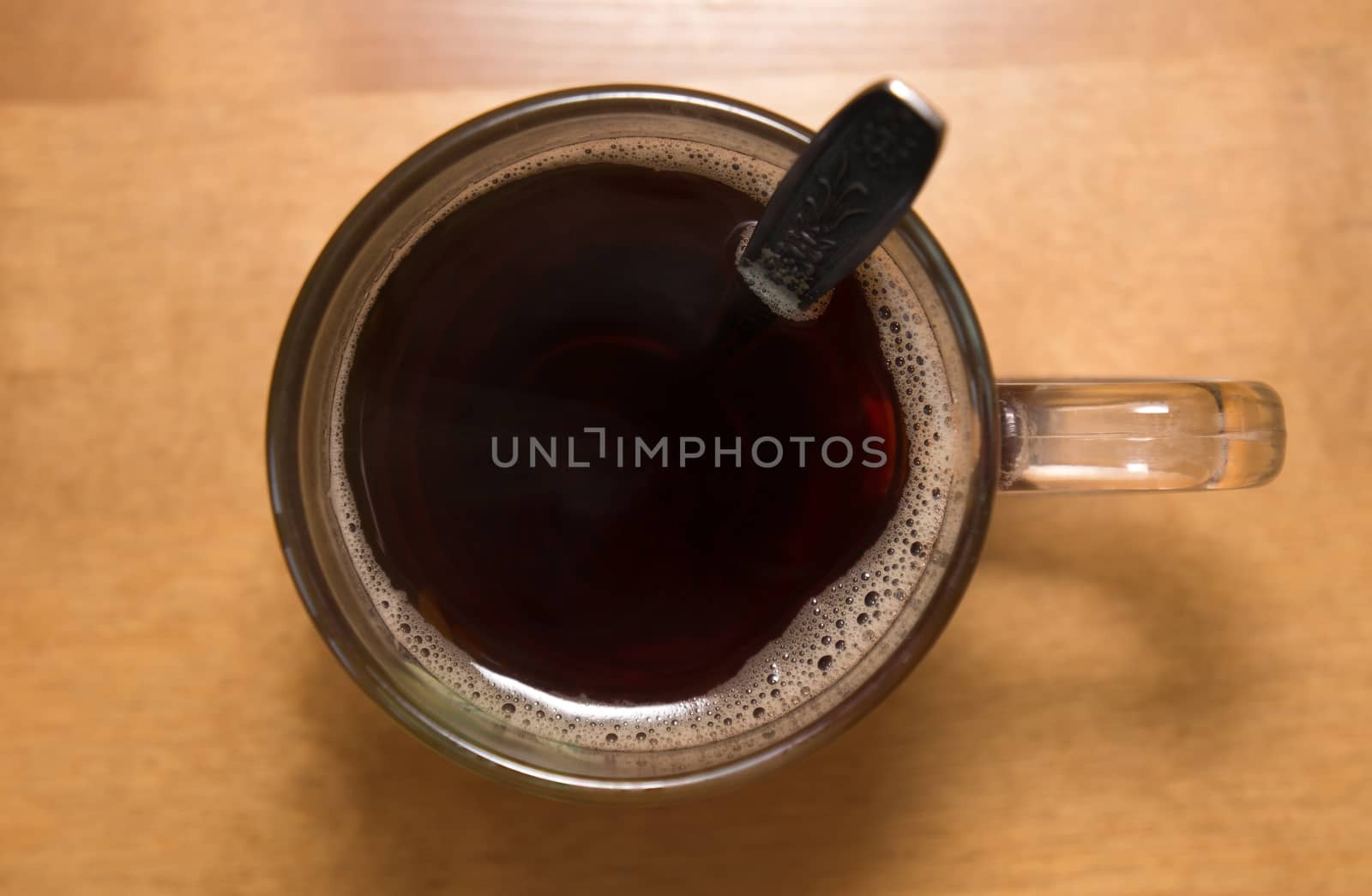 Glass cup of black tea on the table.