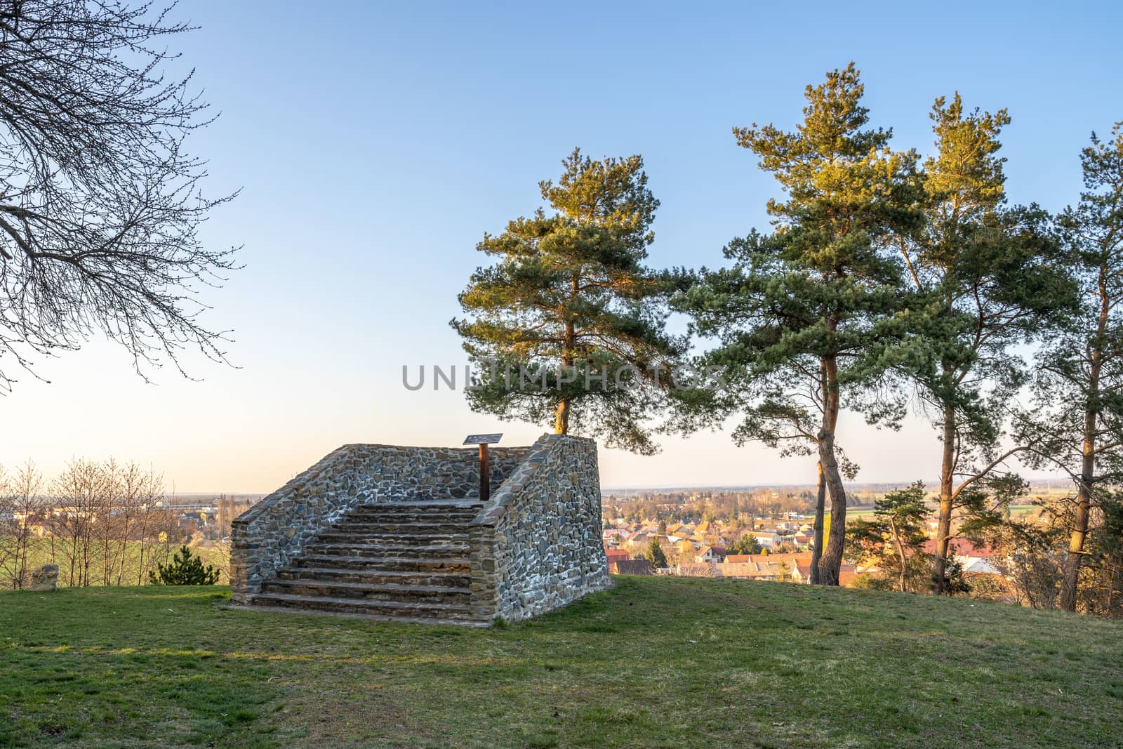 Pichora Marcomanni burial ground south of Dobrichov in the Kolin region Czech republic. Archaeological excavations With small lookout tower near the pine trees with wiew to small city Dobrichov.