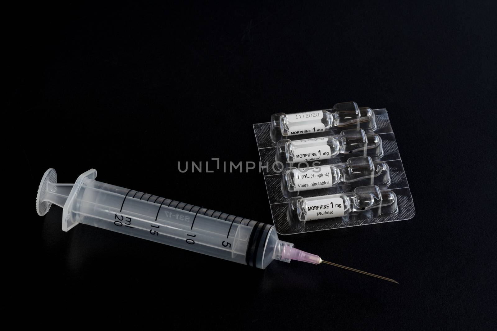 Close-up of liquid morphine sulphate glass vial 1 MG/ML for injections or infusion and syringe