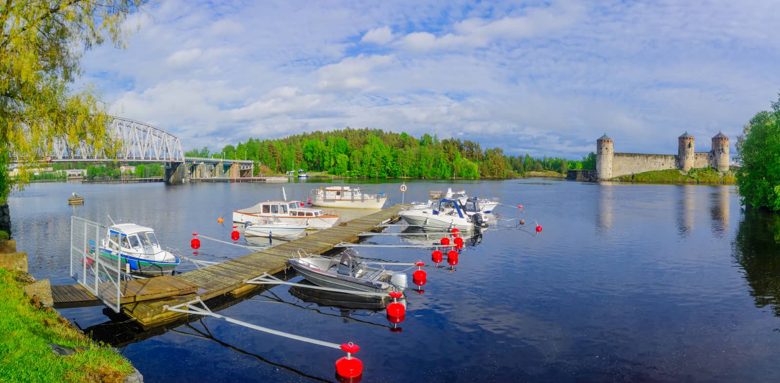 Panoramic view of a train bridge and the Olavinlinna castle in Savonlinna, Finland. It is a 15th-century three-tower castle