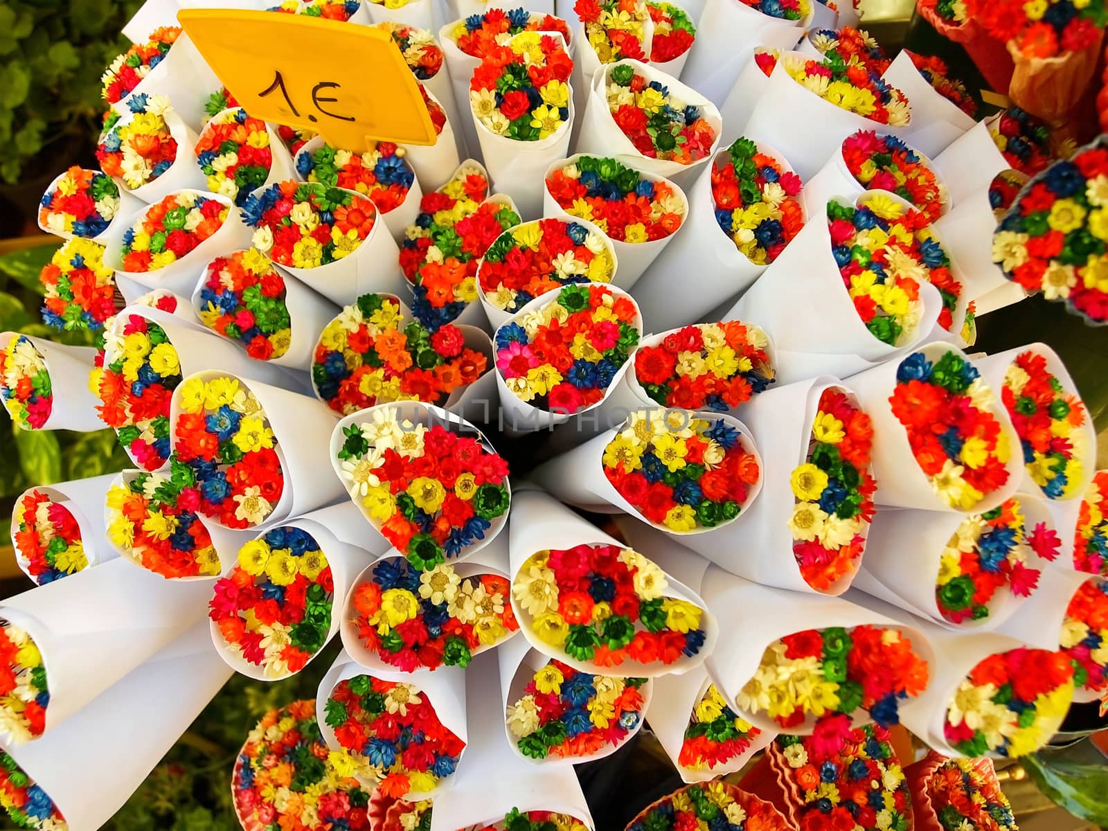 Background of bouquets of dry multi-coloured flowers on the street market in Paris, France.