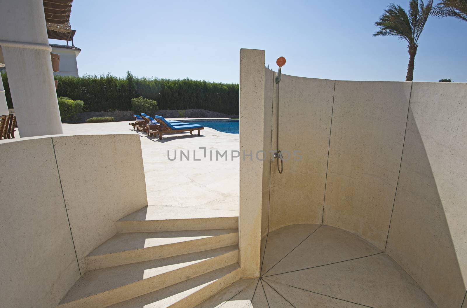 Luxury villa show home in tropical summer holiday resort with swimming pool and outdoor shower