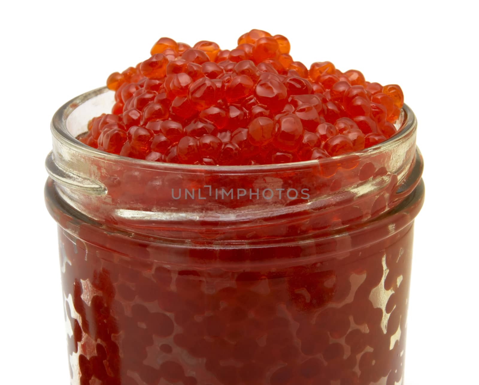 Red caviar into a glass jar isolated over white background