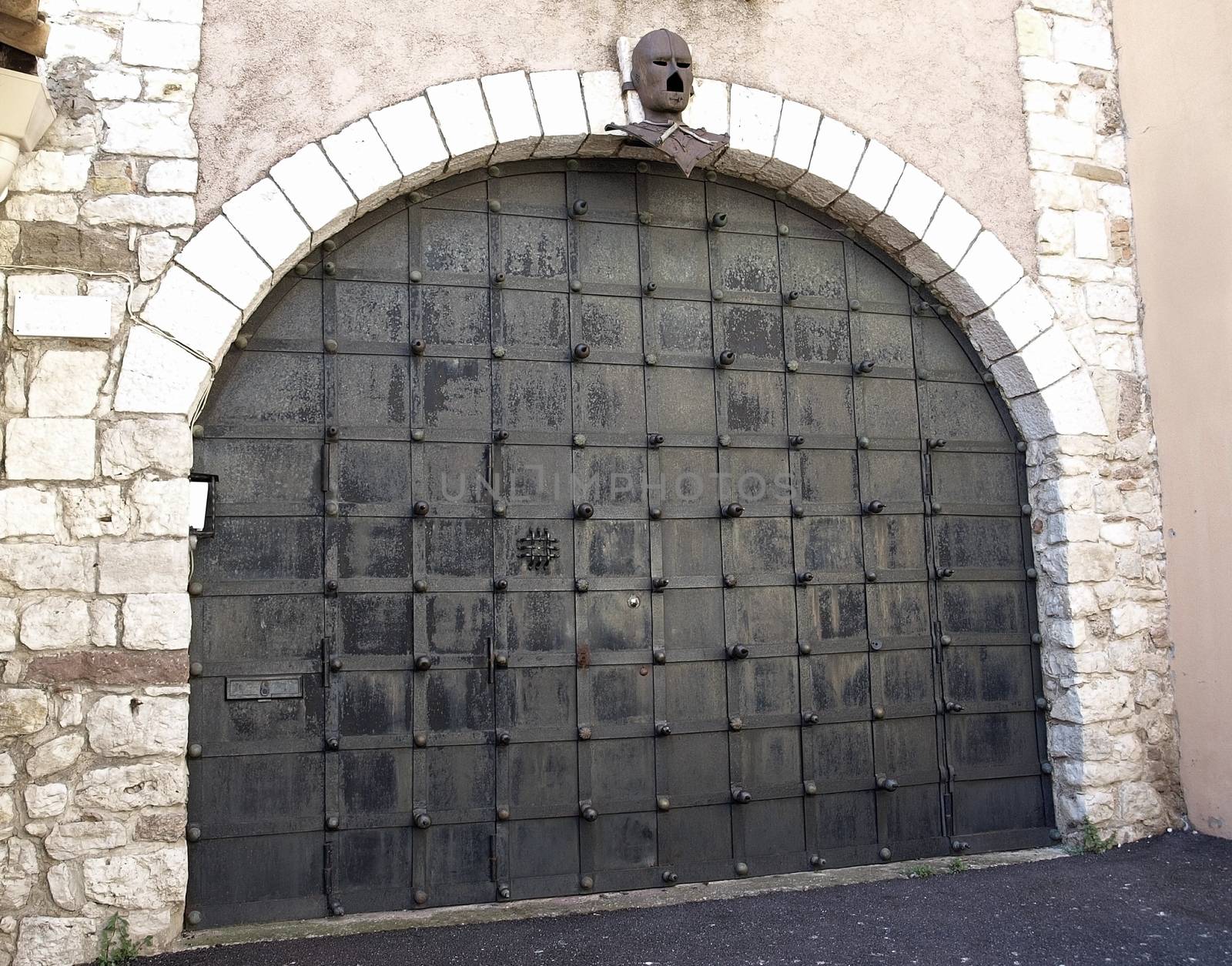 Ancient metal gate with helmet of medieval knight. La Tour Du Suquet in Cannes, France.