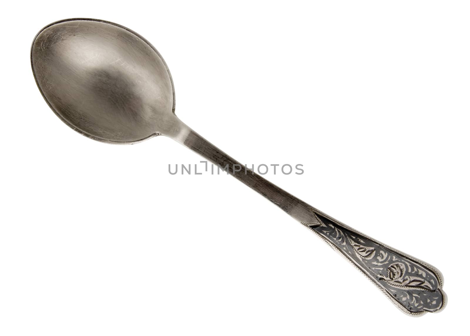 Old silver spoon with ornament isolated on white. Clipping path included