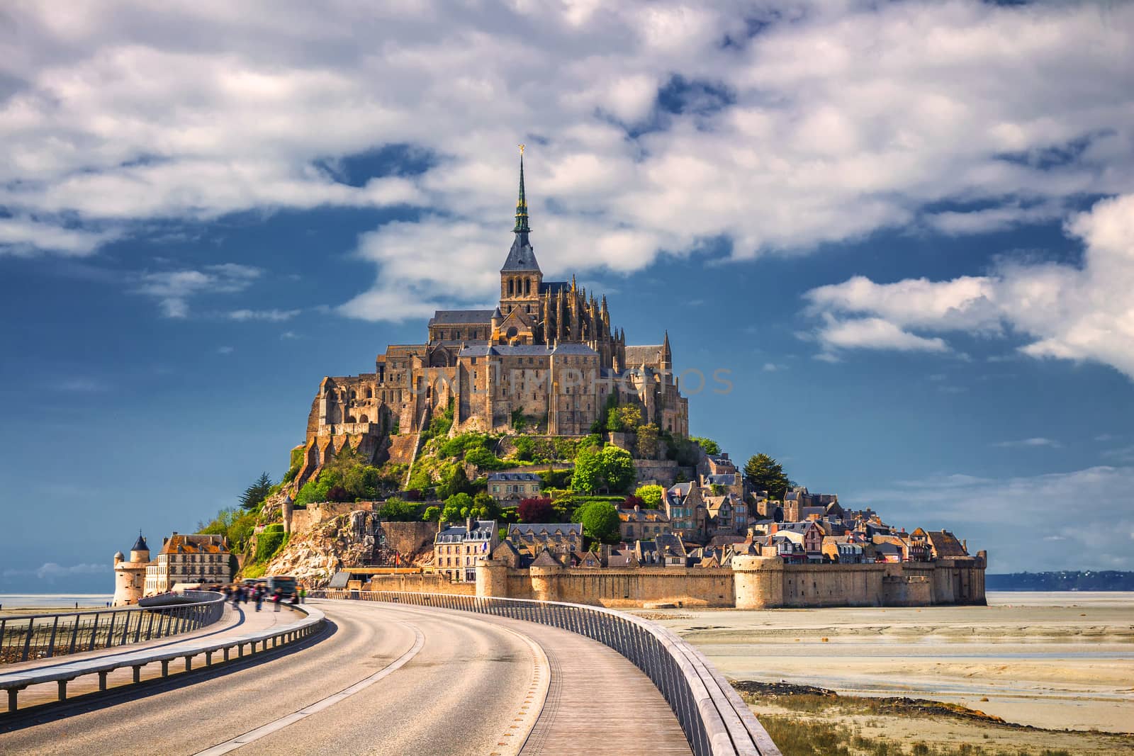 Beautiful panoramic view of famous Le Mont Saint-Michel tidal island with blue sky. Normandy, northern France