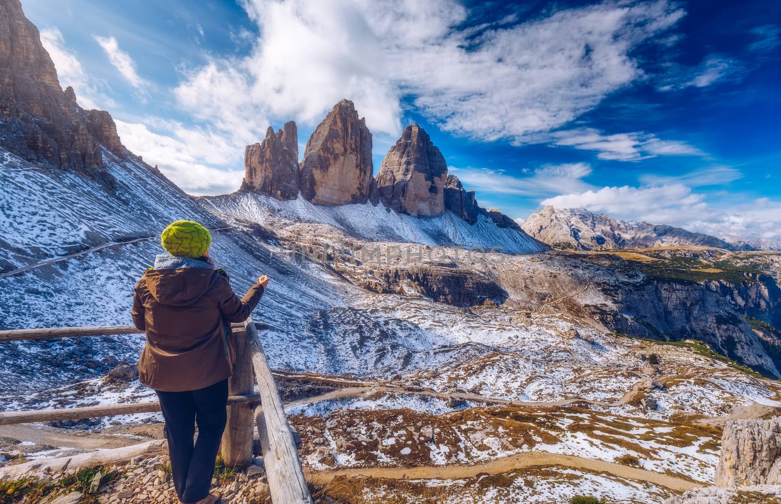 Explorer searching direction with compass in summer mountains, point of view.