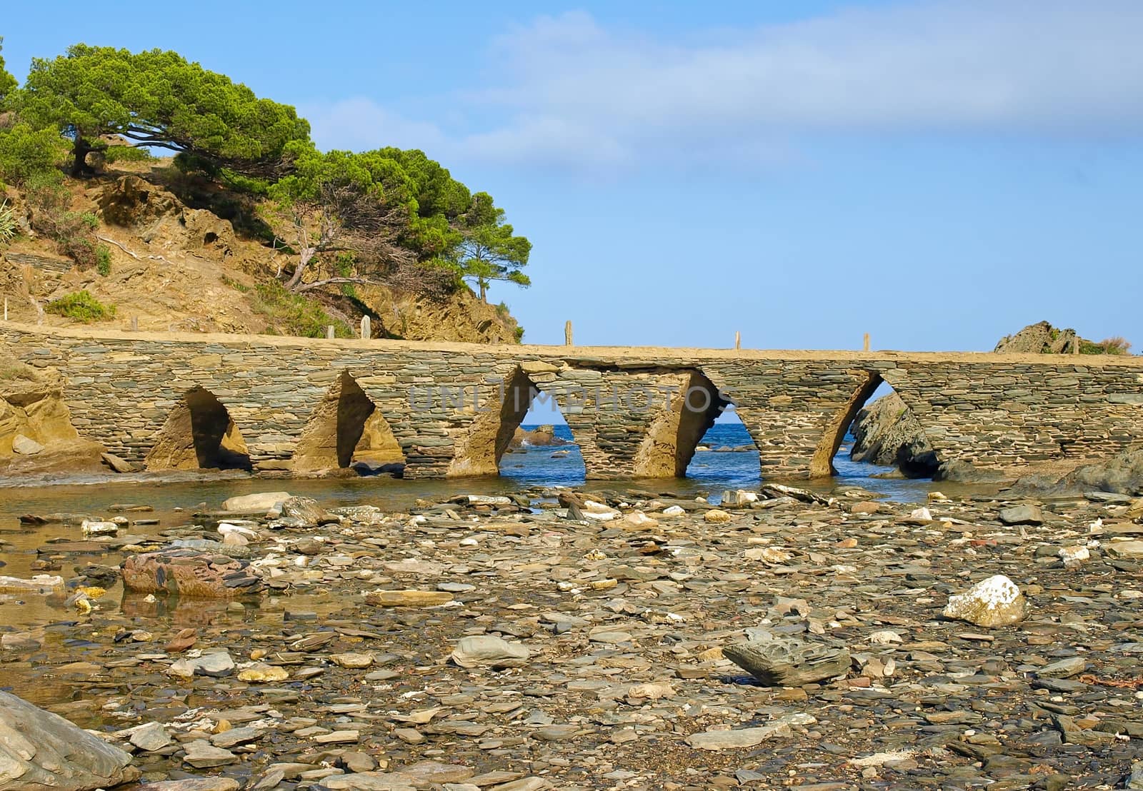 Old ancient stone bridge in Cadaques village, Costa Brava, Catalonia, Spain.