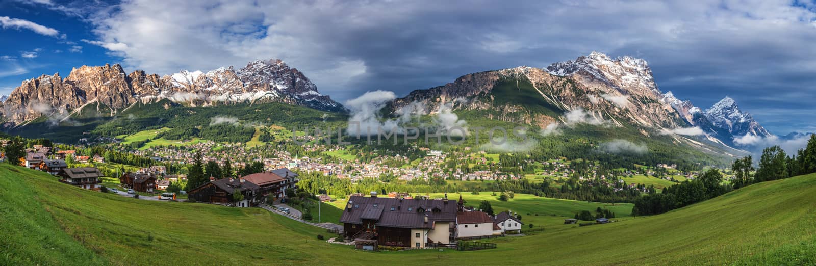 Cortina d'Ampezzo town panoramic view with alpine green landscape and massive Dolomites Alps in the background. Province of Belluno, South Tyrol, Italy.
