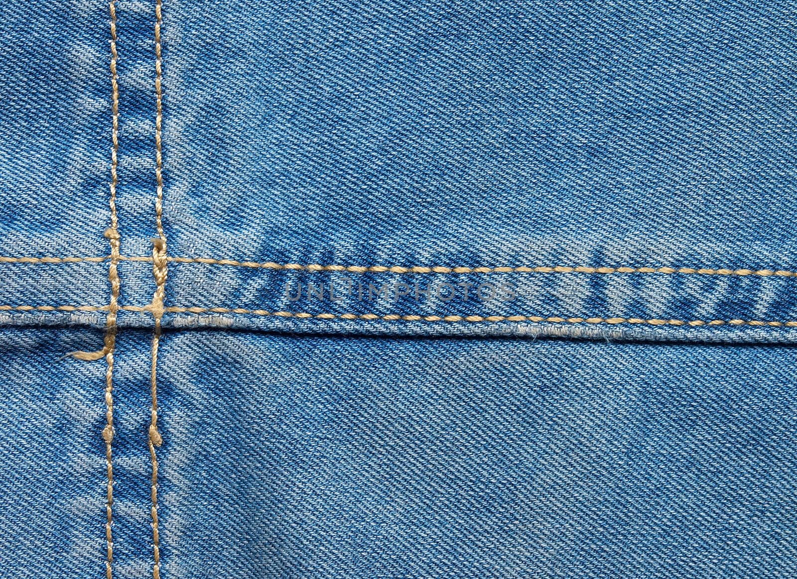 High resolution detail of denim jeans with double-stitched seam.
