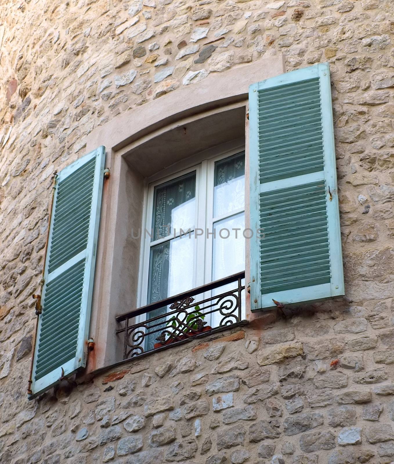 Window on medieval stone wall - Antibes, France