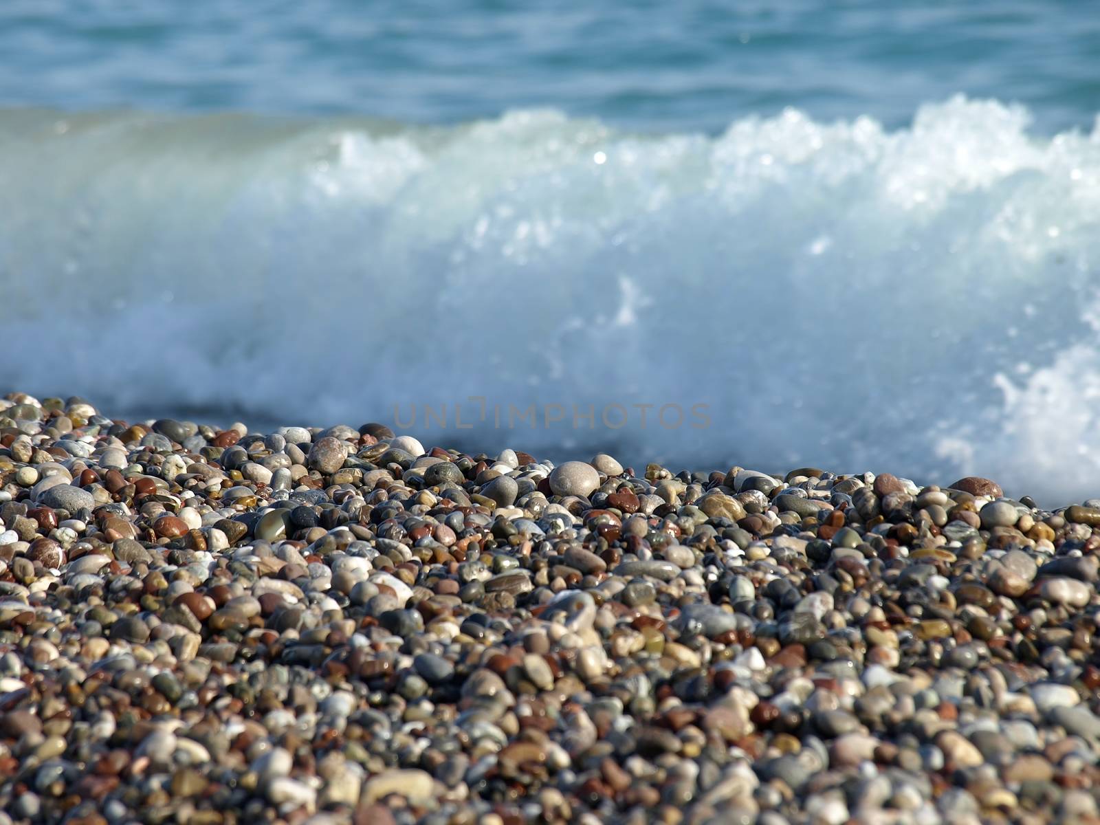 Sea coast from a pebble. Focus on pebbles.