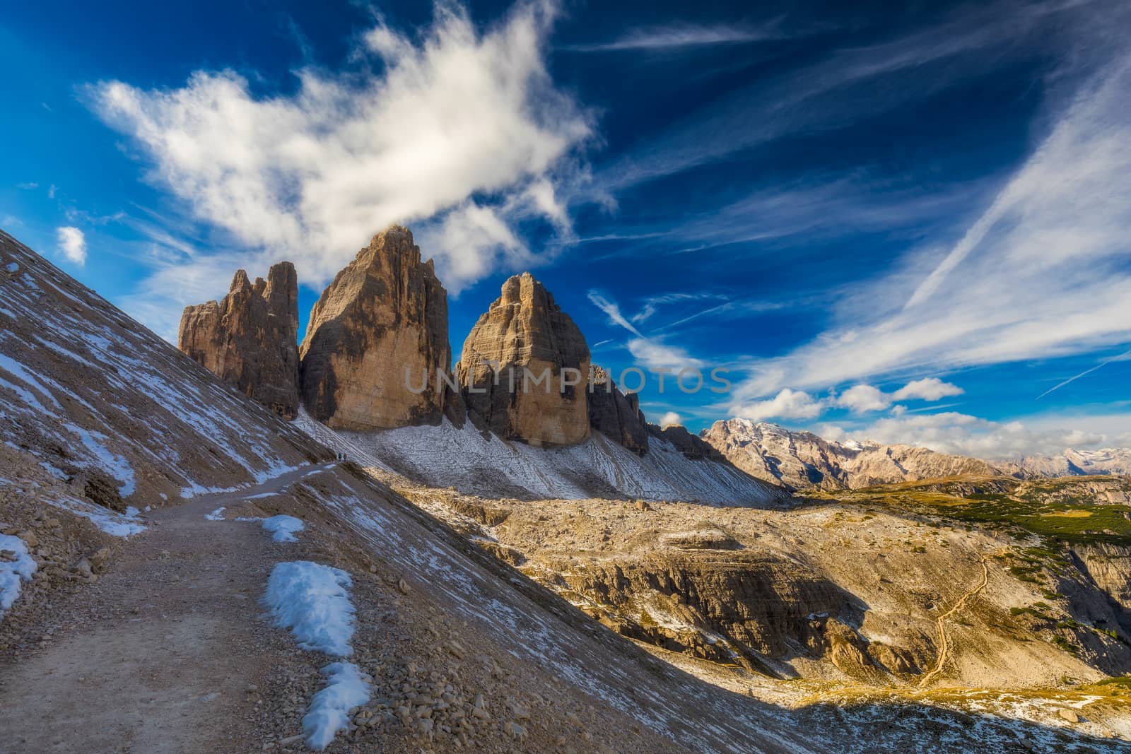 Hiking Trail in Tre Cime di Laveredo. Lake. Meadow. Green Grass. Summer. Blue Sky. Mountain Peak. Dolomites. Italy. Tre cime are one of the best-known mountain groups in the European Alps