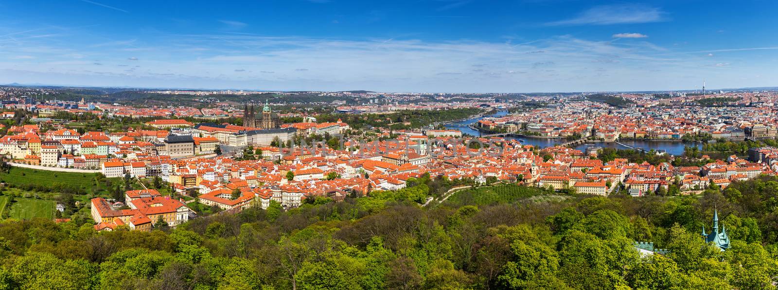 Aerial view of old Red Tiles roofs in the city Prague, Czech Republic, Europe. Beautiful day with blue sky with clouds in the town.