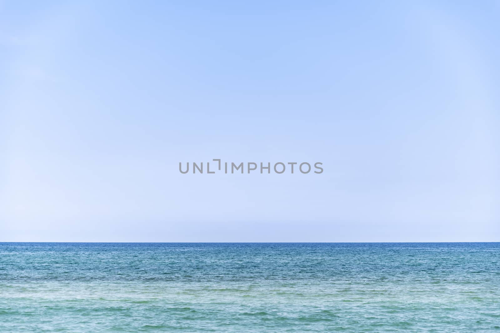 mediterranean sea during summer with large copy space in the light blue sky, Ghisonaccia, Corsica, France (looking to the horizon)