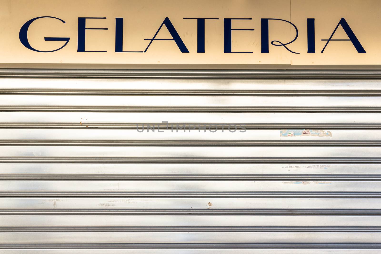 An old Italian ice cream shop with the lowered shutter.