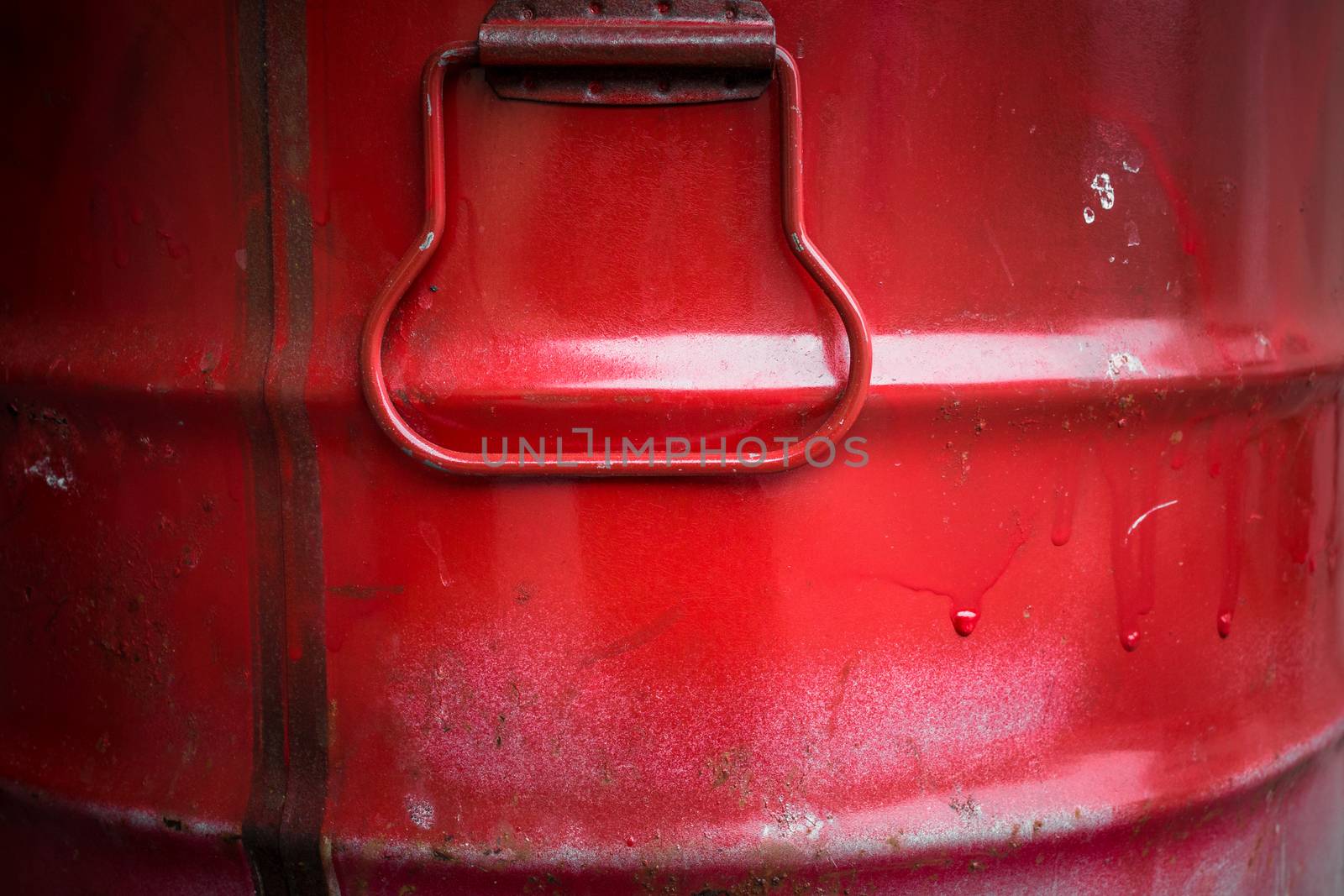 Extreme close up of a red barrel of oil.