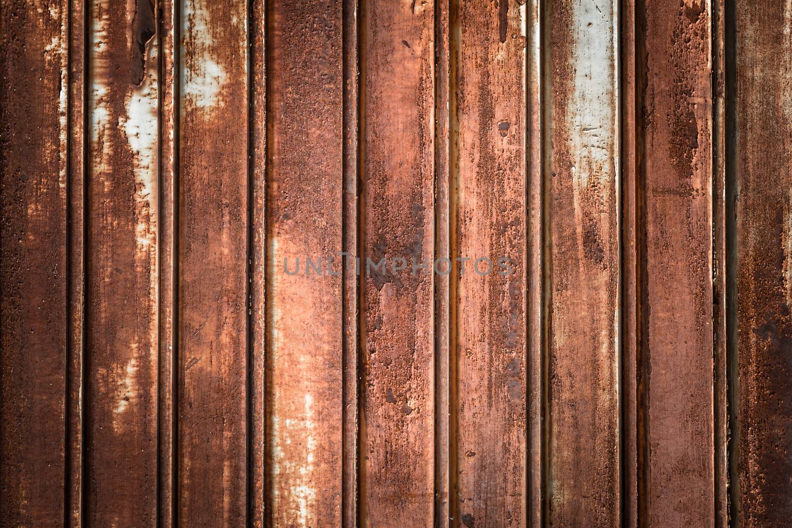 Front view of a shutter rusted, deteriorated from elements.