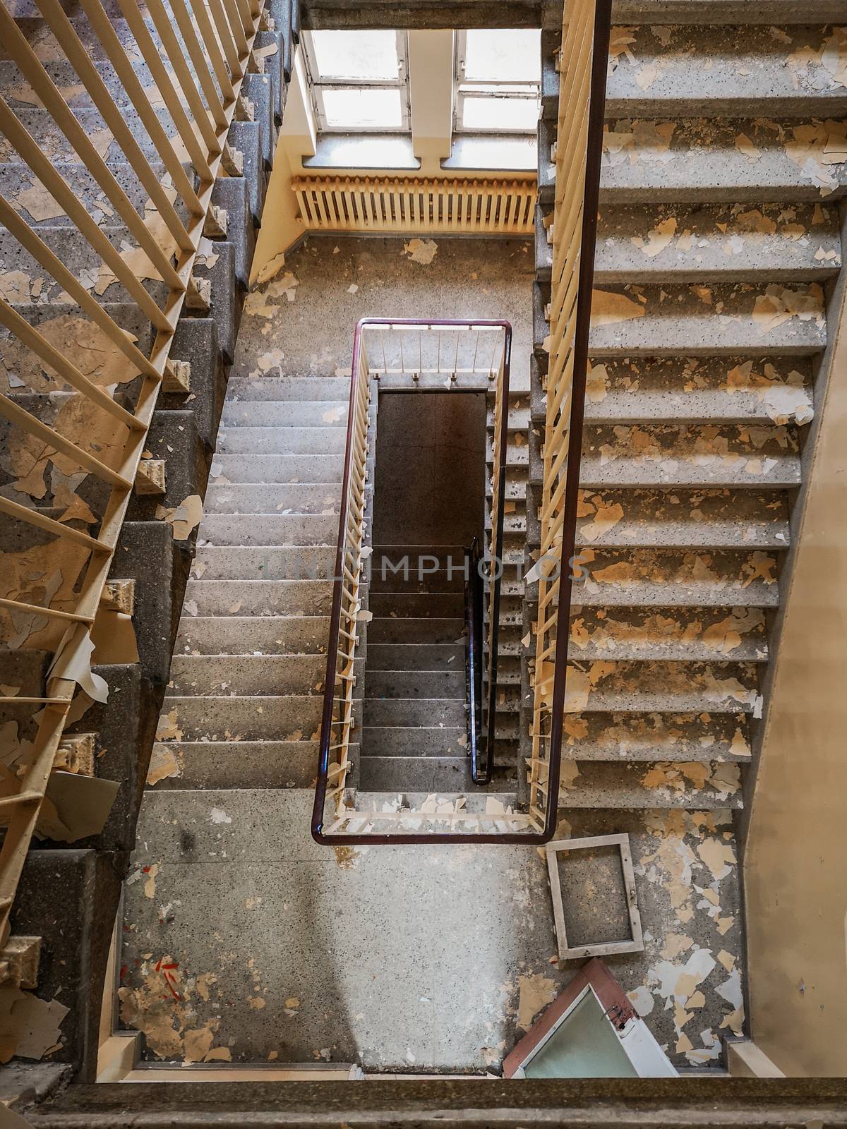 Dirty square spiral staircase in old abandoned hospital