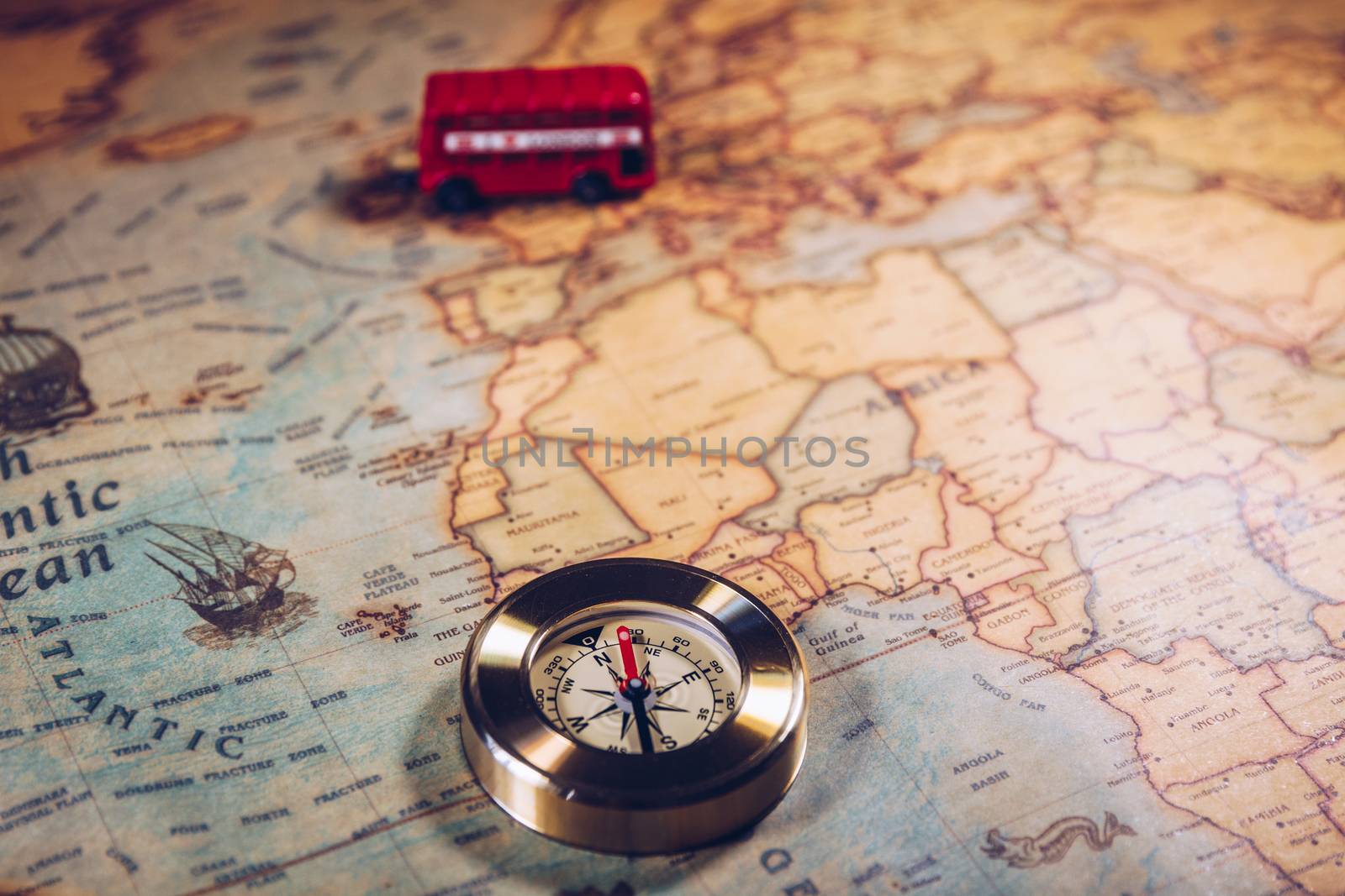 The iconic red bus and Big Ben miniature with compass on the map of London, UK. Concept of travel.