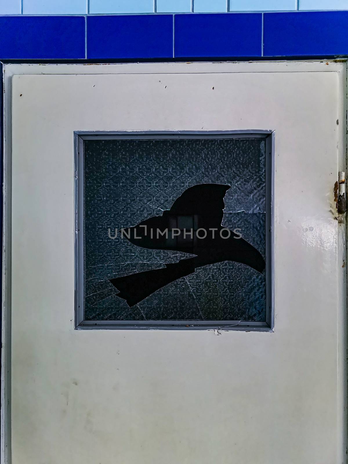 Broken glass in doors in old abandoned hospital