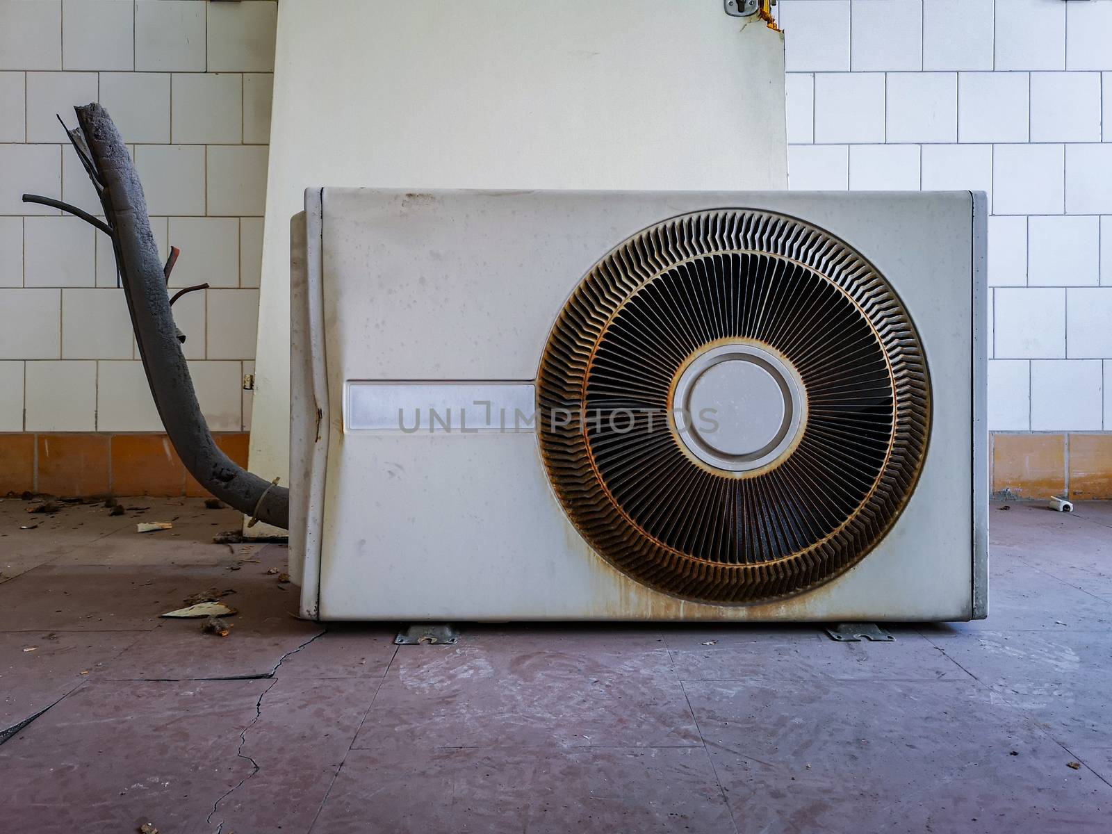 Old destroyed air conditioner on floor in old abandoned hospital