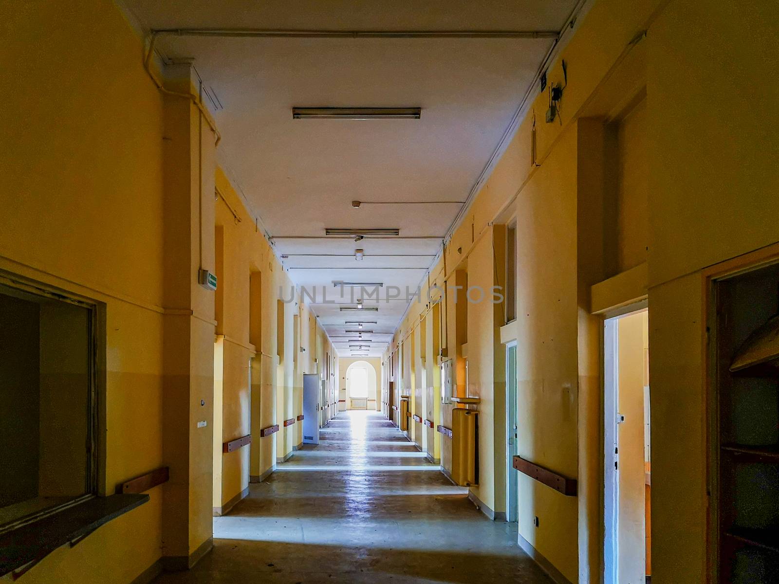 Long corridor with lights and shadows from removed doors