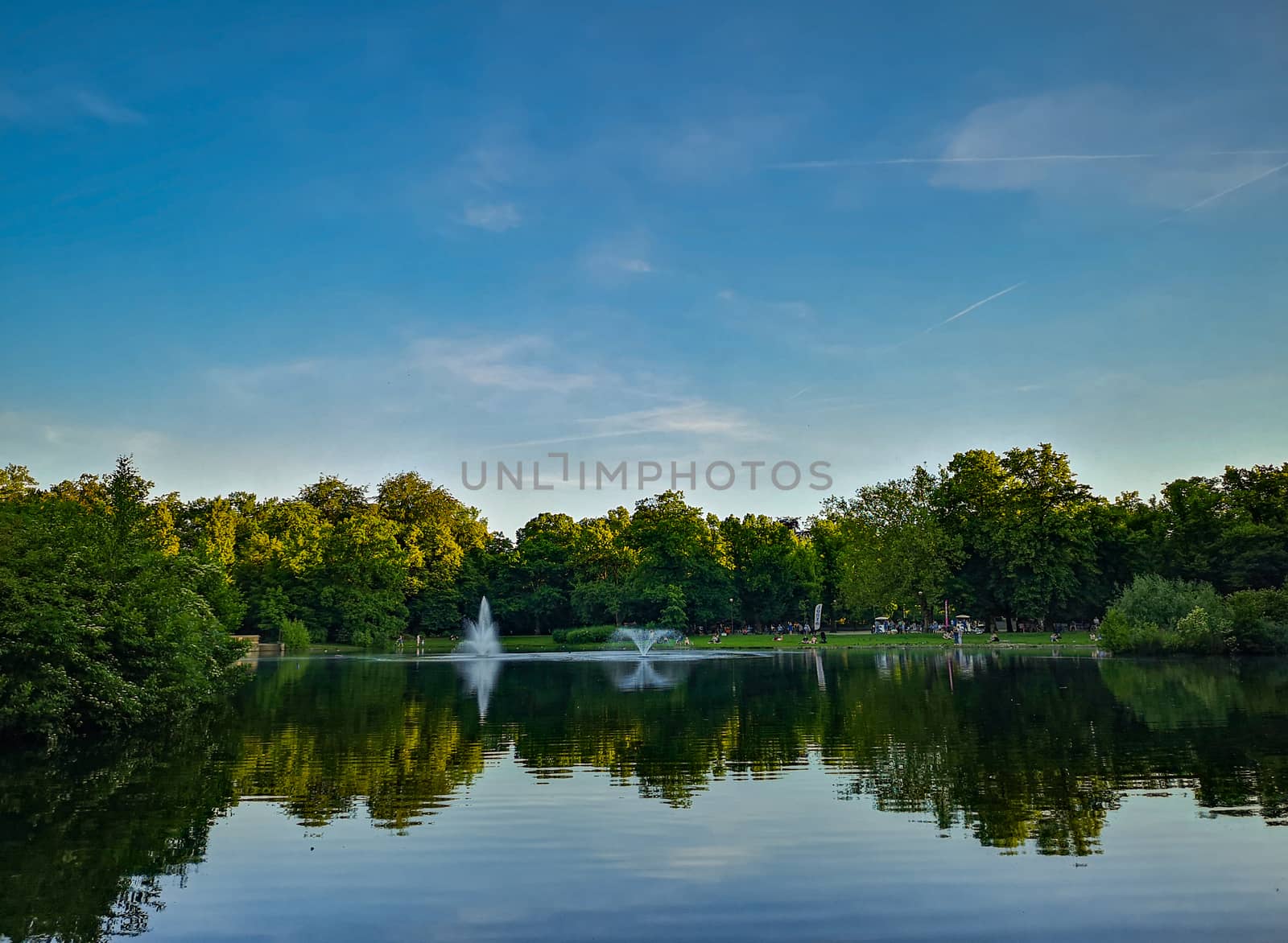 Beautiful sunny day in south park with fountains on lake in Wroclaw city 