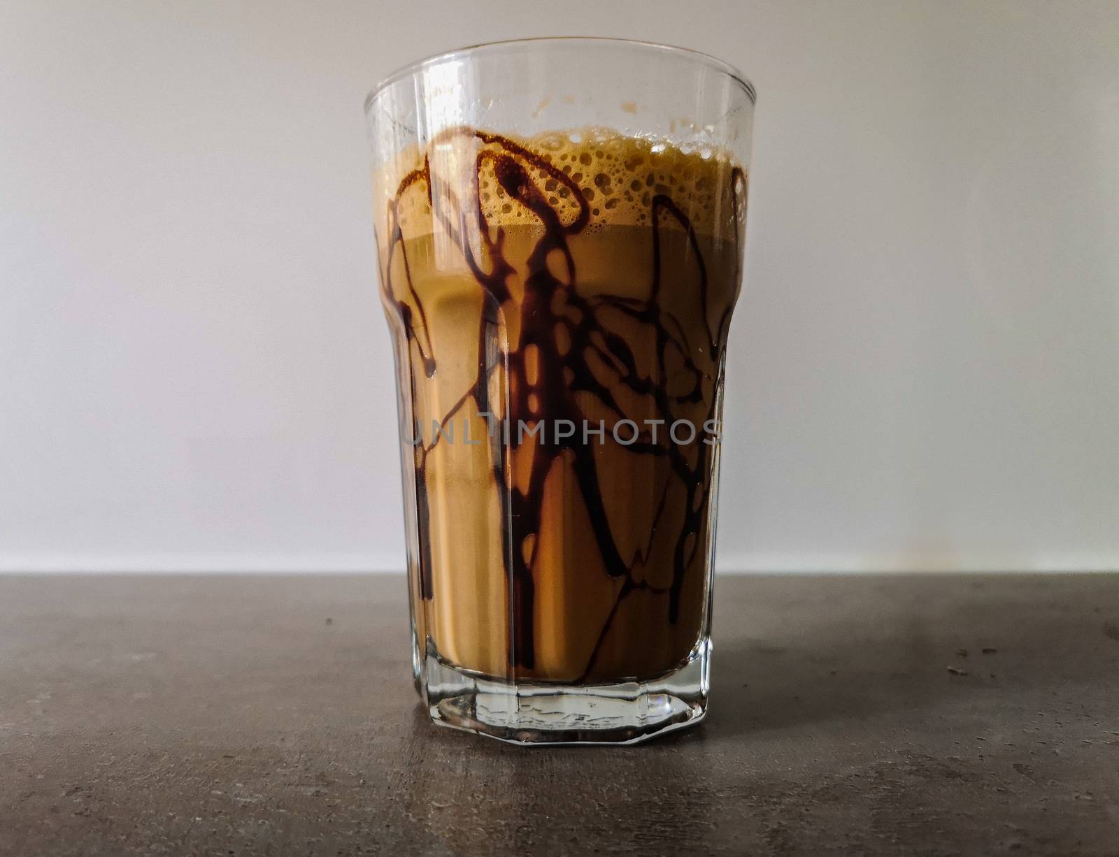 Ice shaked coffee with chocolate souce on glass 