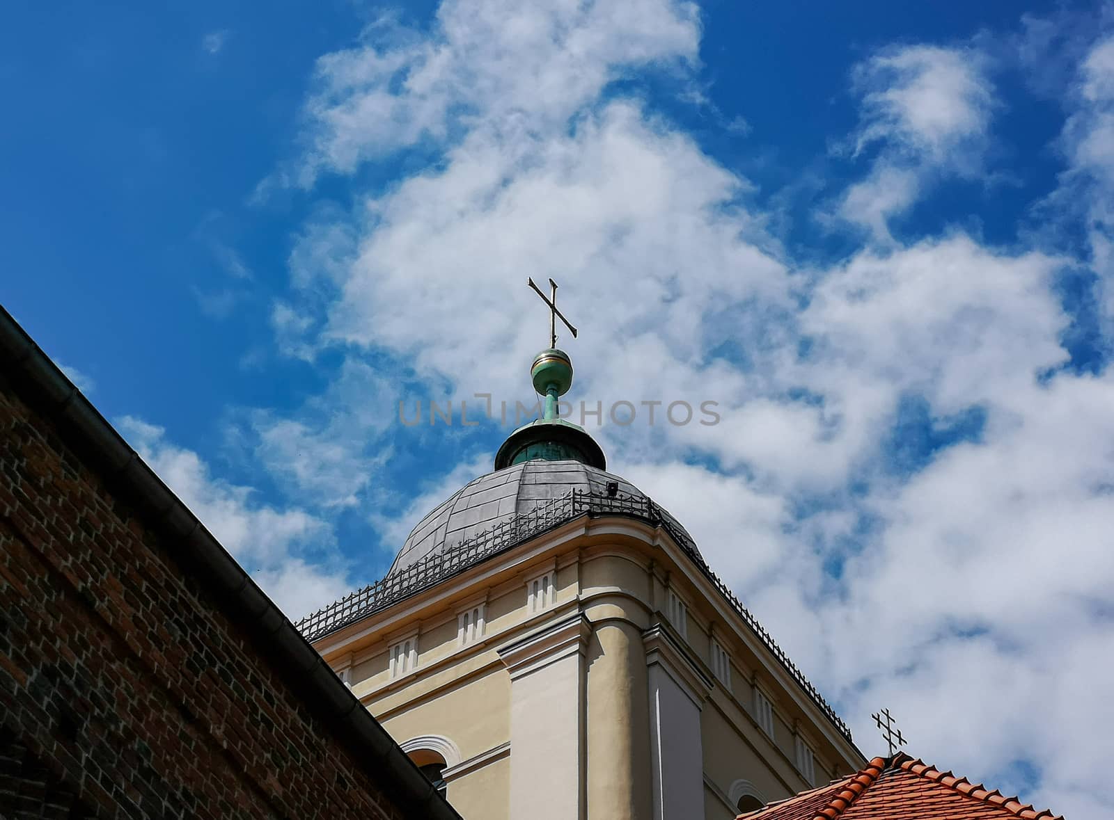 Top of the tower with metal cross at end by Wierzchu