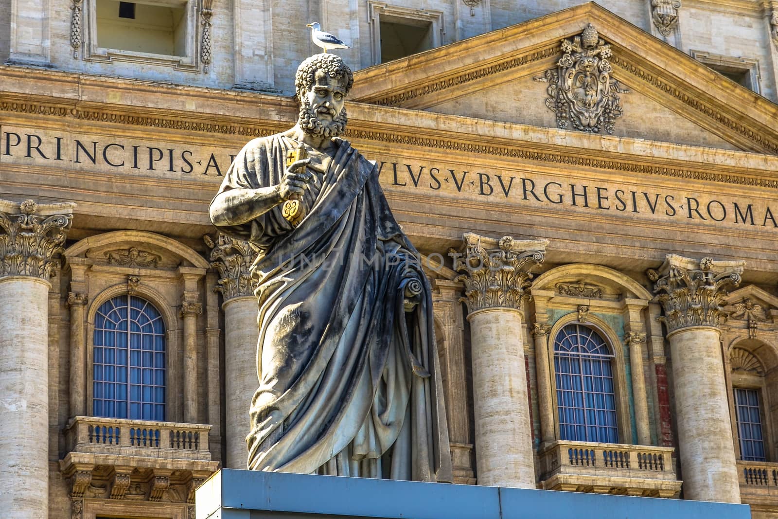 Statue of Saint Peter and Saint Peter's Basilica at background in St. Peter's Square, Vatican City, Rome, Italy