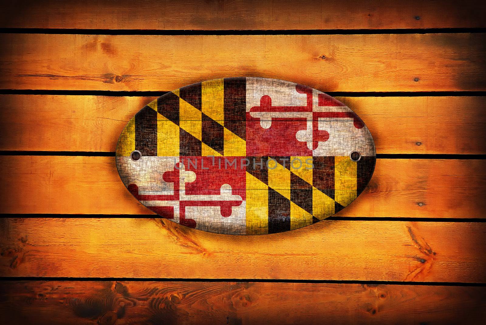 A Maryland flag on brown wooden planks.