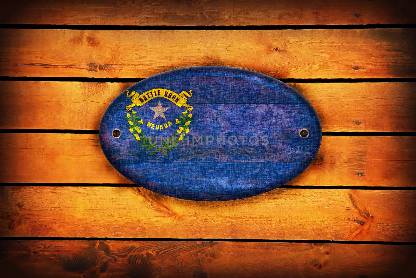 A Nevada flag on brown wooden planks.