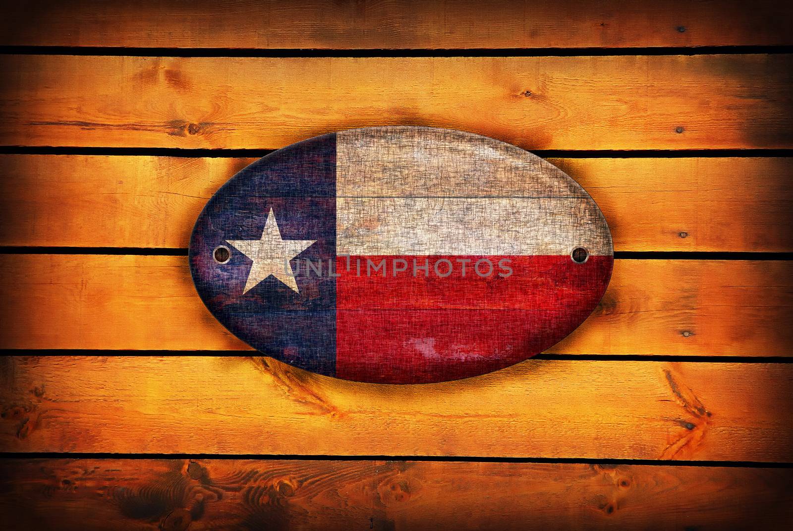 Texas flag on brown wooden planks.