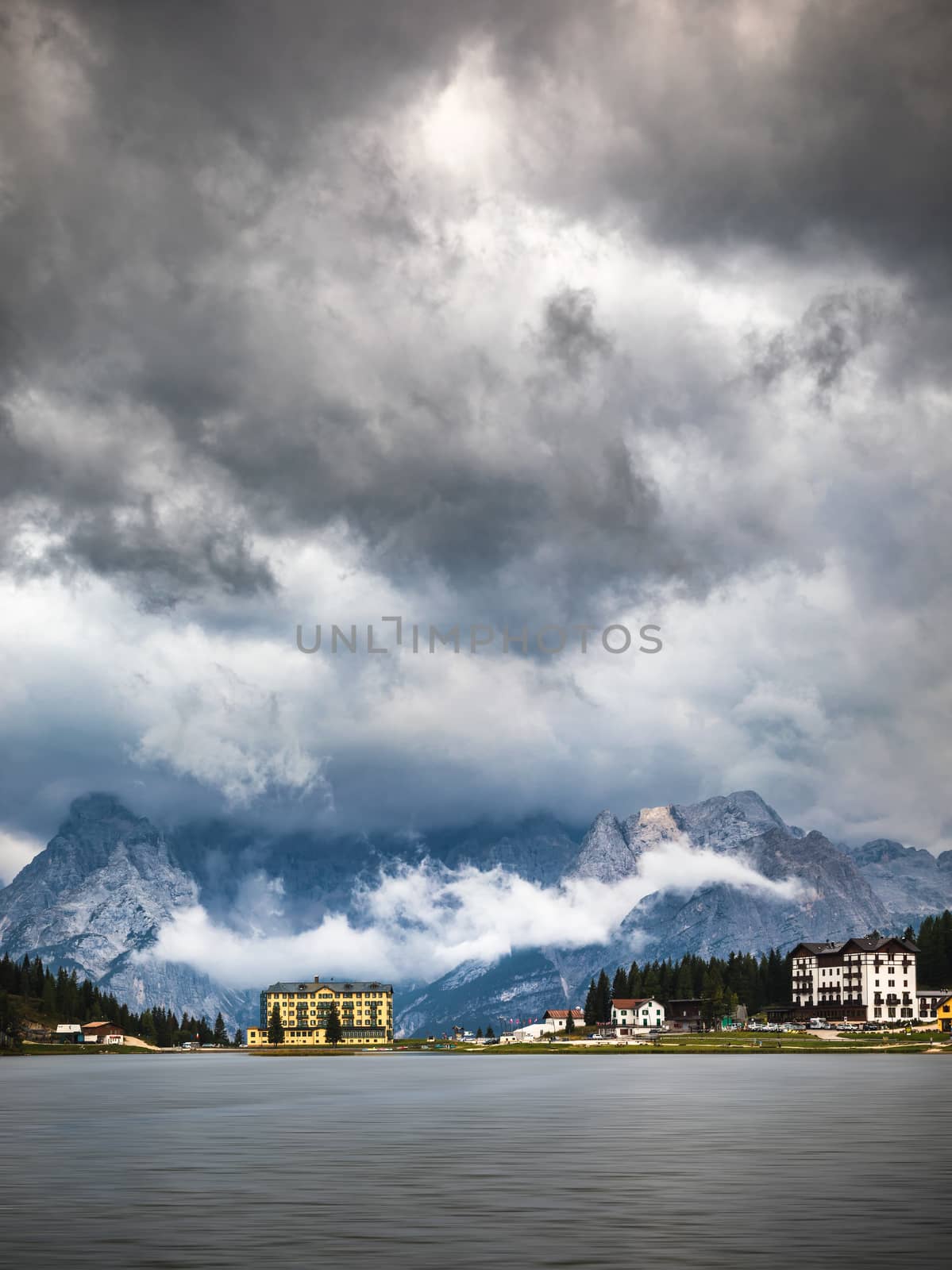 Misurina Lake in the Dolomites mountains in Italy near Auronzo di Cadore on a cloudy day, Sorapiss mountain in the background. South Tyrol, Dolomites, Italy.