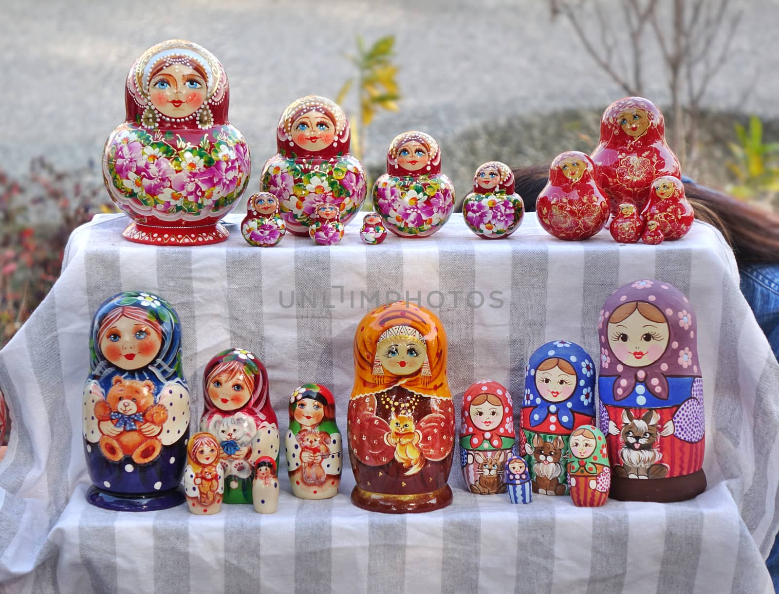 KAOHSIUNG, TAIWAN -- JANUARY 19, 2020: A street vendor sells Russian style wooden Matryoshka dolls in various colors and designs.
