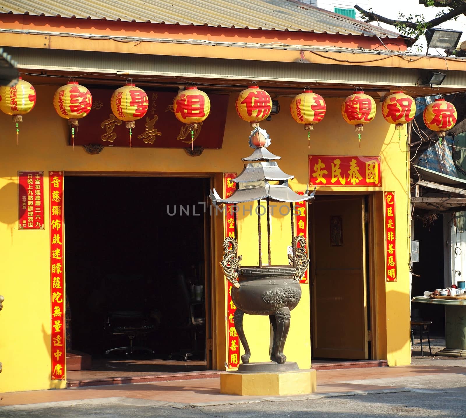 KAOHSIUNG, TAIWAN -- JANUARY 30, 2014: The small Miao-San Temple in Kaohsiung is decorated with colorful lanterns for the Chinese New Year.