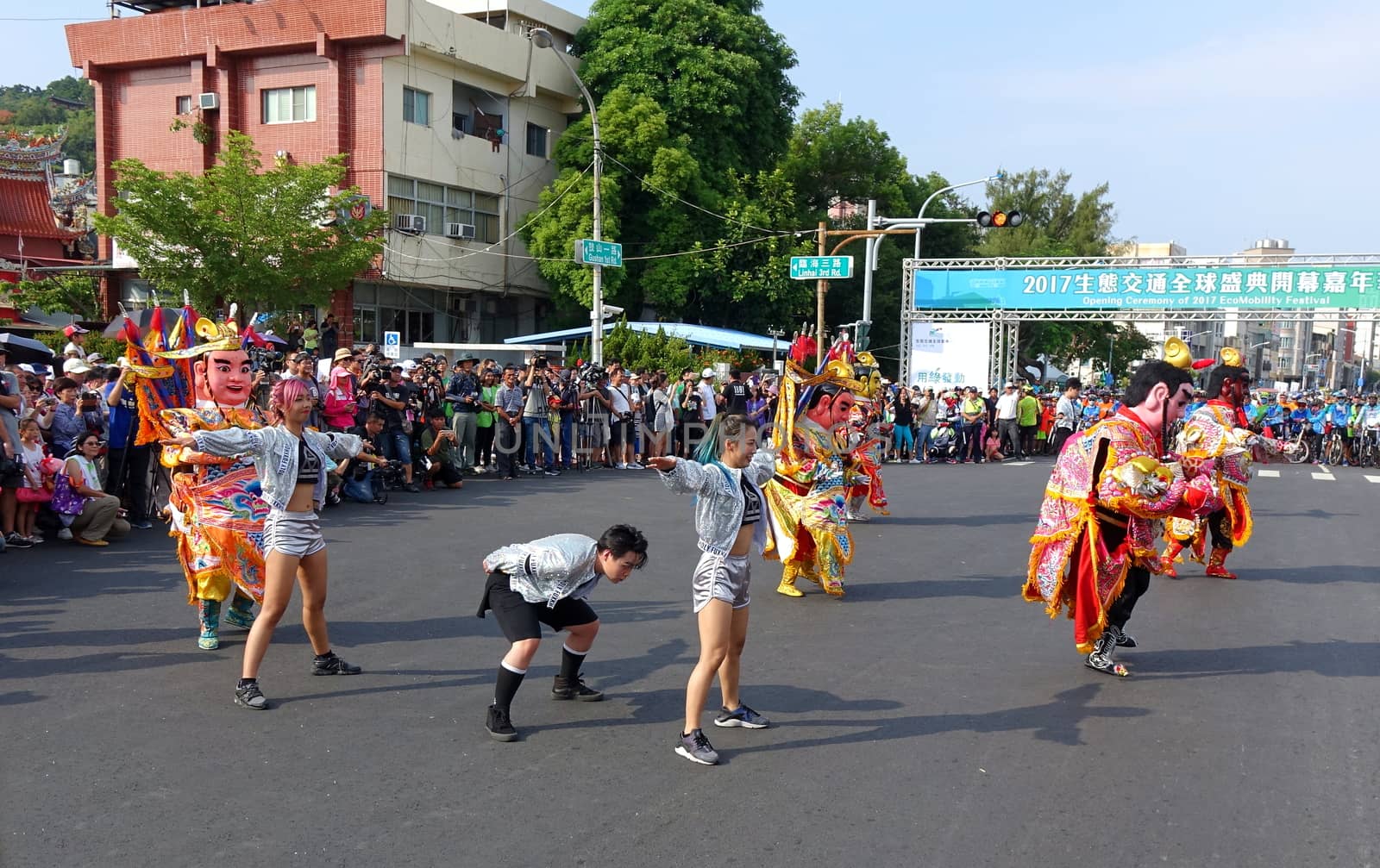 KAOHSIUNG, TAIWAN -- OCTOBER 1, 2017: Young people and traditional temple dancers perform at the opening of the 2017 Ecomobility Festival.