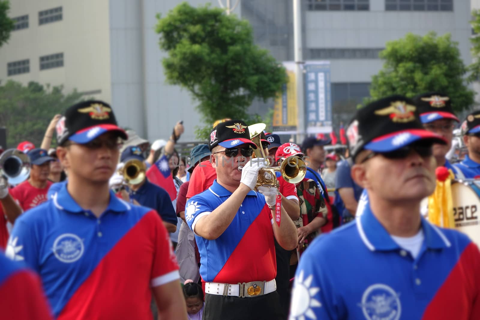 KAOHSIUNG, TAIWAN -- OCTOBER 10, 2019: A marching band dressed in national flag colors takes part in the national day celebrations at a free, public event. 
