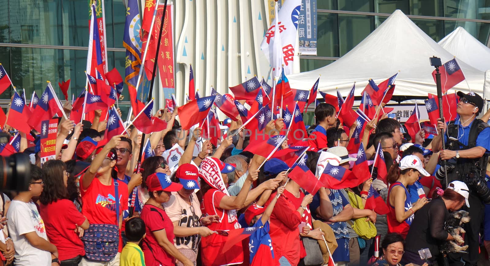 KAOHSIUNG, TAIWAN -- OCTOBER 10, 2019: An excited crowd waves national flags during the national day celebrations at a free, public event.