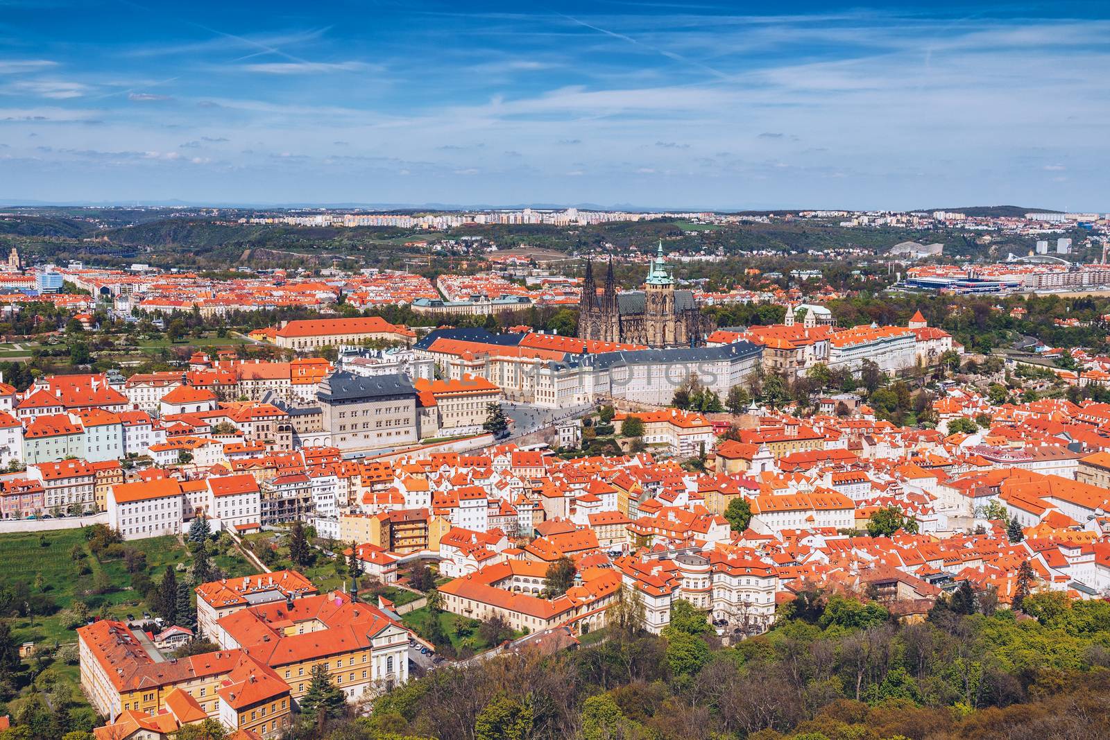 erial view of old Red Tiles roofs in the city Prague, Czech Republic, Europe. Beautiful day with blue sky with clouds in the town.