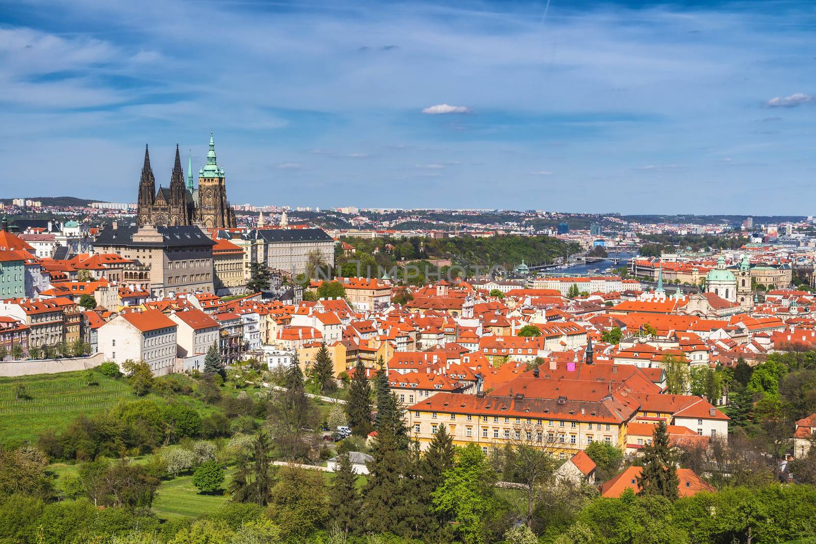 erial view of old Red Tiles roofs in the city Prague, Czech Republic, Europe. Beautiful day with blue sky with clouds in the town.