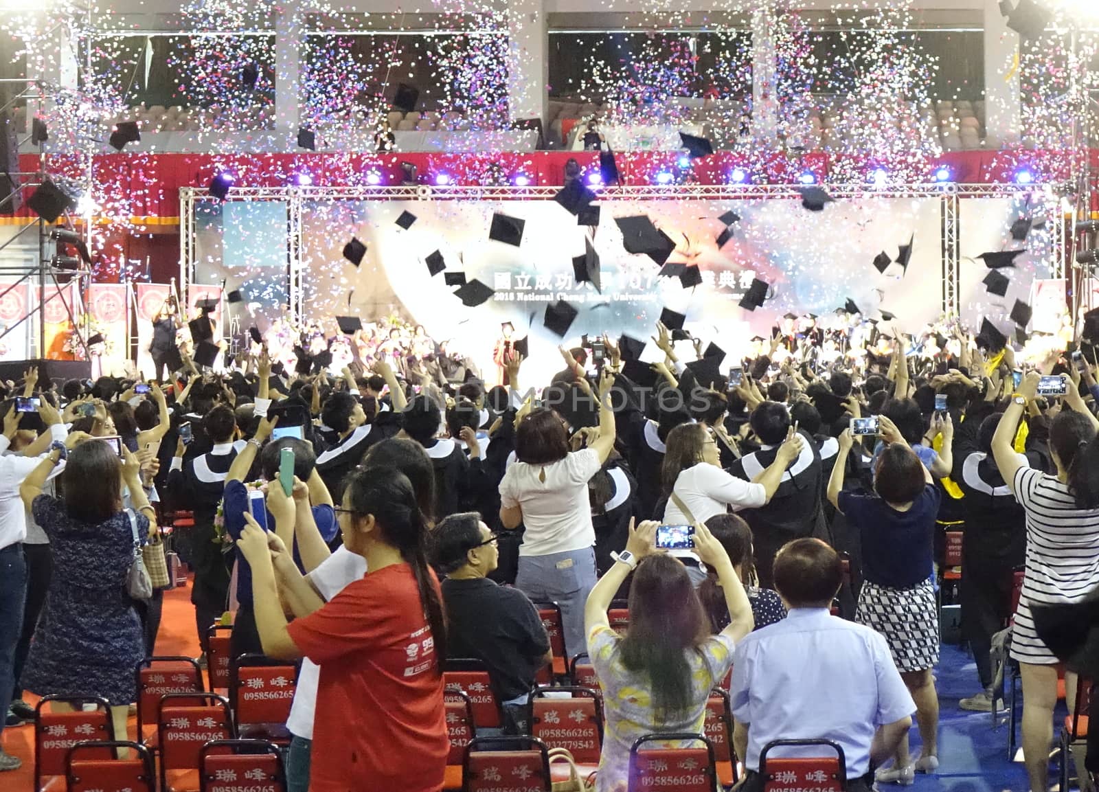 TAINAN, TAIWAN -- JUNE 2, 2018: Graduates throw their caps into the air at the annual graduation ceremony of NCKU university.
