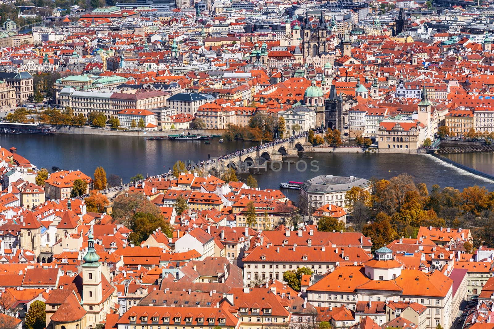 Autumn aerial view of houses and roofs of Prague old city town including Charles bridge. Czech Republic