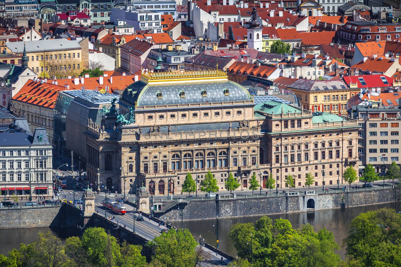 View of the Prague National Theater on a bright sunny day along the Vltava River, Czech Republic