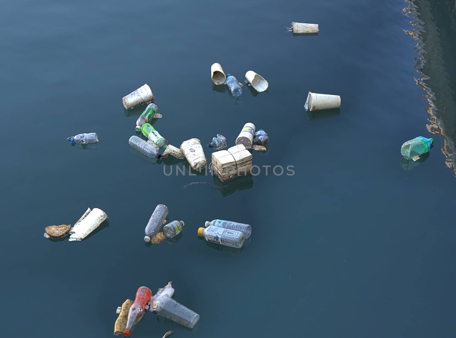 KAOHSIUNG, TAIWAN -- JUNE 2, 2019: Plastic bottles and polystyrene cups pollute Kaohsiung Harbor